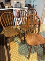 Front view showing all four chairs in matching finish and condition