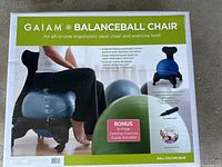 Box showing front view of Gaiam Balanceball Chair with image of person sitting and exercise ball chair visible, branding and features including ergonomic design and exercise guide