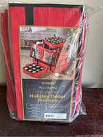Photo showing the packaged red Zober holiday decor storage container with label visible.