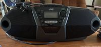 Front view of black JVC CD portable stereo system with integrated speakers.