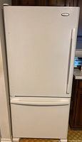 Front view of closed refrigerator/freezer showing full unit and handle