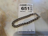 Photo of antique sterling Albert link watch chain bracelet laid flat on a marble surface showing overall length and chain links.
