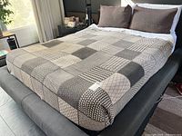 Queen size bed with the wool blanket and two matching brown pillow shams; shows overall lot condition and color scheme.