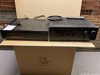 Yamaha RX-770 stereo receiver and Sony CD player side by side on a shelf, with remote control on top of receiver.