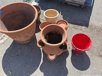 Overview of all pots showing variety in size, color, and condition.