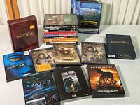 Full view of DVD lot showing a variety of titles including Avatar, The Lord of the Rings box sets, King Kong Special Edition, Batman Begins, and several miscellaneous DVDs stacked.