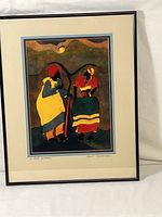 Full view of framed art print 'A Path Between' showing two figures in colorful traditional dress.