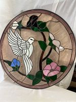 Full view of round stained glass panel featuring white dove, flowers, leaves, and pink border.