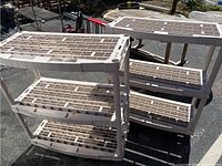 Two beige Rubbermaid plastic shelving units with grid-style shelves, showing overall structure and size.
