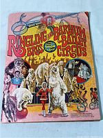 Front cover of the 1976 Ringling Bros and Barnum & Bailey Circus souvenir book showing vibrant artwork with circus animals and performers.