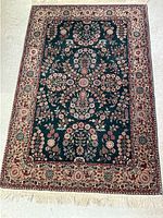 Full view of the entire wool area rug showing the overall floral design and colors.