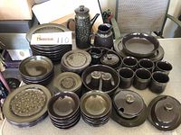 Full view of Franciscan Madeira dinnerware collection arranged showing plates, bowls, mugs, server pieces