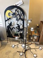 Full lot with black metal Halloween yard sign and black metal tree shaped candle holder with multiple glass cup holders on each branch.
