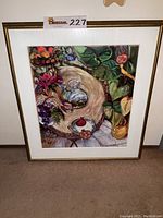 Framed and matted colorful print titled 'Mediterranean Birdseed' by Lynn Hays, includes fruits, plants, and decorative tableware