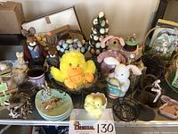 Overview of spring and Easter decorations with plush animals, ceramic figures, nests, baskets, plates, and topiaries.