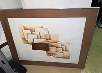 Framed abstract art print with overlapping rectangular shapes in warm tones, view of entire artwork and framing.