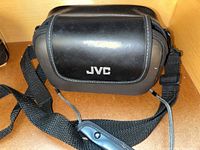 Black JVC branded carrying case for camcorder, shown closed with strap