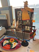 Overall view of the painted plate and metal kinetic figurine together.