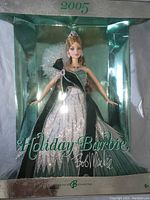 Front view of boxed 2005 Mattel Bob Mackie Holiday Barbie doll dressed in green tones with box.