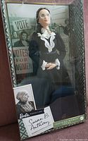 Full view of boxed Susan B. Anthony Barbie doll with historical suffrage background