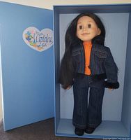 Doll displayed inside original blue box with Maplelea logo visible