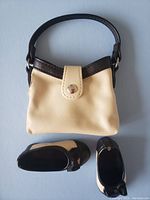 Set of cream purse with black trim and matching cream and black shoes for dolls