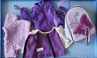 Overview of all clothing items and accessories including purple jackets, sweater, eyeglasses, case and backpack