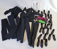 Overview of Ken doll wedding attire including jackets, pants, shoes, cummerbunds, and booklet.