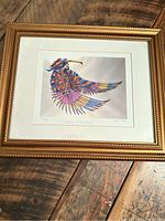 Full view of framed Native American style bird print by Don Chase. Copper-colored frame and white mat visible.