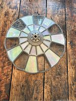 Top view of stained glass lamp shade showing iridescent colored glass panels arranged in a circular design with lead caming