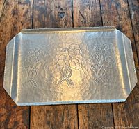 Top view of the vintage aluminum tray showing floral embossing and hammered texture