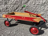 Side view of vintage Jetliner wagon showing wooden bed with red painted sides and wheels