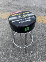 Angle view showing padded seat top graphics with 'FREE INSPECTION', Napa and WRP logos, and service text 'STRUTS - SHOCKS - EXHAUST'.