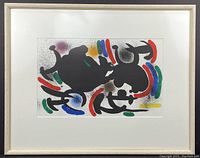 Overall view of framed lithograph with white-washed wood frame and archival mat surrounding abstract print.