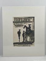 Overall view of the black and white print mounted with acid-free white matting on foam board, showing the full artwork with abstract silhouettes of men and horse rider underneath a shaded area.