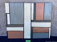 Full view of the painting showing geometric colored blocks separated by black lines on board.