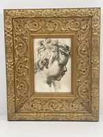 Frontal view of the framed boy's profile portrait showcasing the ornate gilt frame.