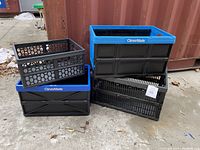 Four collapsible crates stacked showing different sizes and styles, two have blue trim and CleverMade branding.