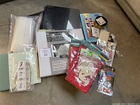 Top view of the scrapbooking supplies including scrapbook, photo album, and various craft items