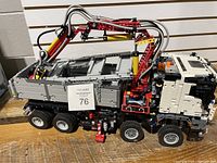 Front-angle view of assembled truck showing cab, grille, crane and dump bed