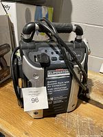 Motomaster Eliminator unit showing front, top with handle and attached cables