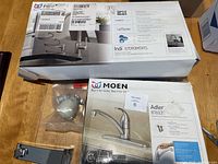 Photo showing Moen Indi 87090MSRS pulldown kitchen faucet box with features like Spot Resist finish, PowerClean spray, Reflex system, and retractable spray wand.