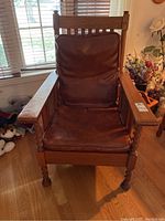 Front view of oak mission-style armchair with vinyl seat and back cushions