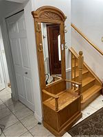 Full front-angle view of oak hall tree showing arched mirror, bench seat and hooks