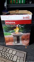 Front view of Wilshire firebowl box showing image of firebowl