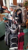 Full set of clubs standing in Callaway bag in basement setting