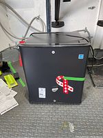 Front view of black Visa mini fridge showing locking mechanism and keys.