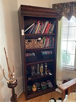Full view of the five shelf cabinet showing the design and contents for size reference.