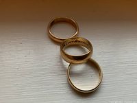 Three rings arranged in overlapping row on light surface