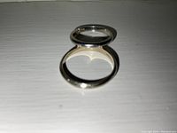 Two white gold bands stacked, showing differing widths.